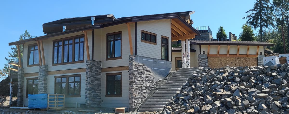 Custom home with Hardie siding, stone accents, and timber beams
