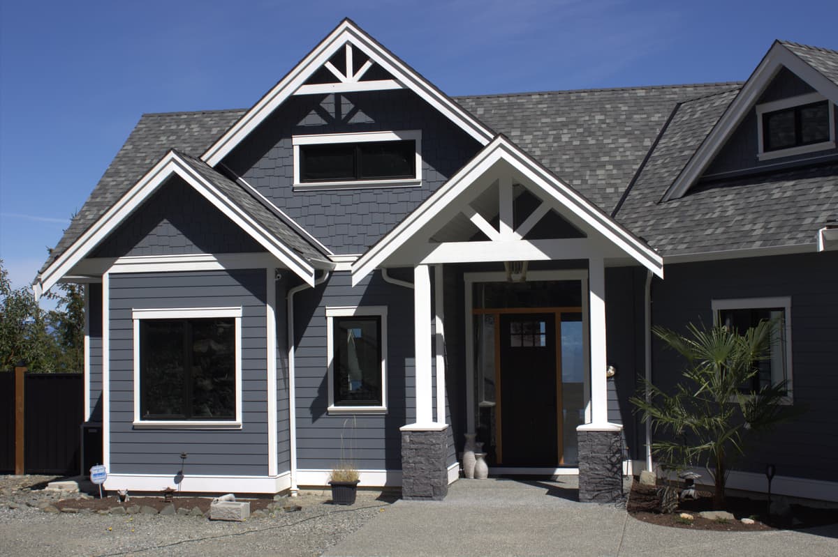 Dark blue craftsman with white trim and cedar shake accents