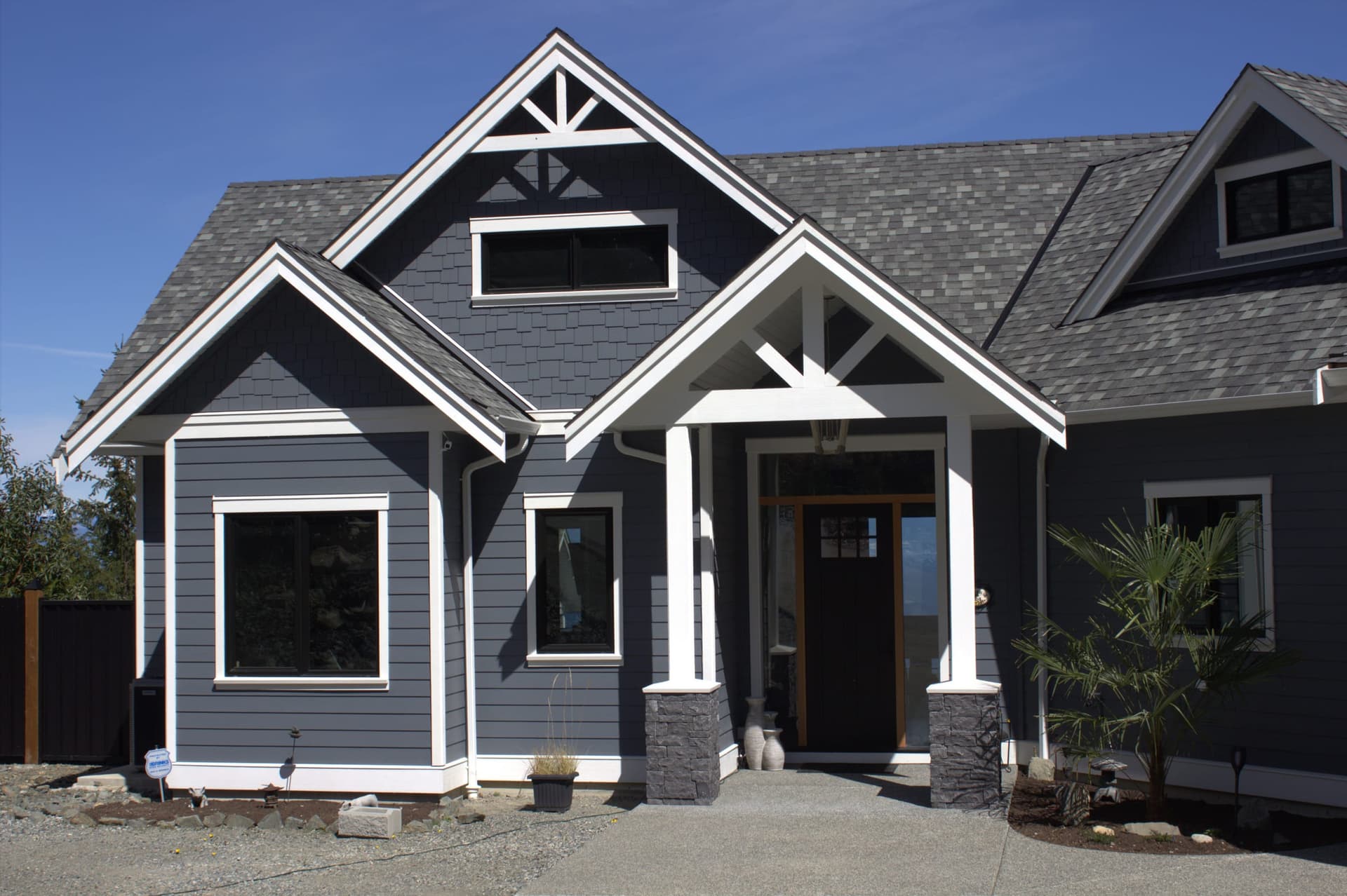 Dark blue craftsman with white trim and cedar shake accents