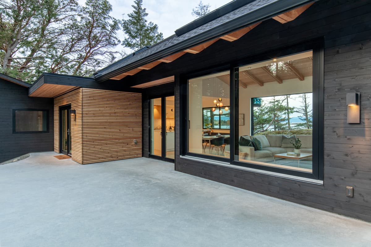 Dark stained wood siding with cedar slat accent and ocean view